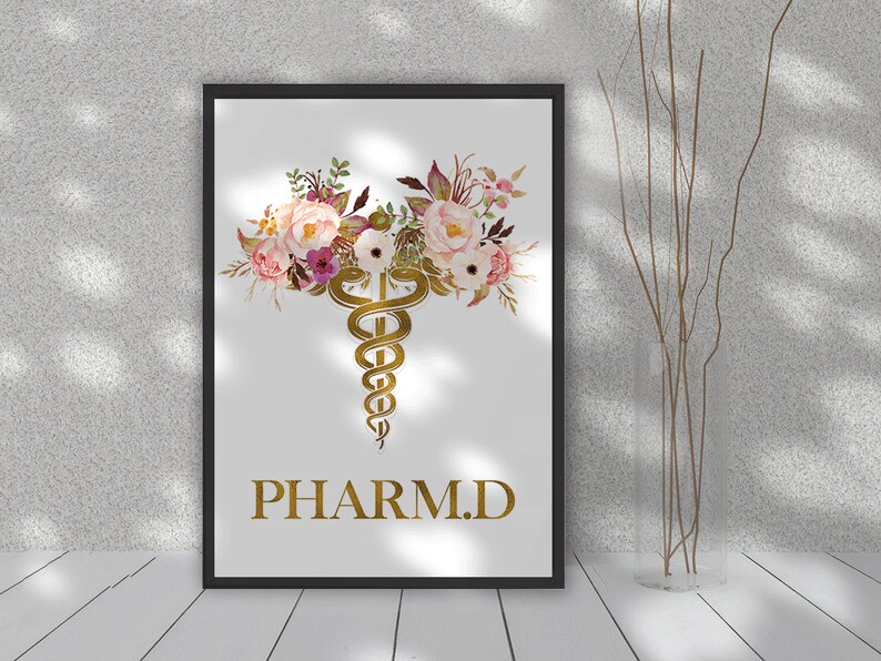 May include: A white printable poster with a gold caduceus symbol surrounded by pink and white watercolor flowers. The text "PHARM.D." is written in gold below the symbol.