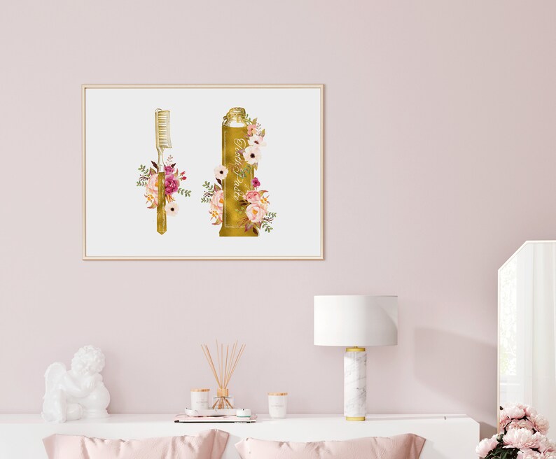 May include: A gold-colored toothbrush and tube of toothpaste with floral accents. The toothbrush and toothpaste are surrounded by pink, white, and green flowers.