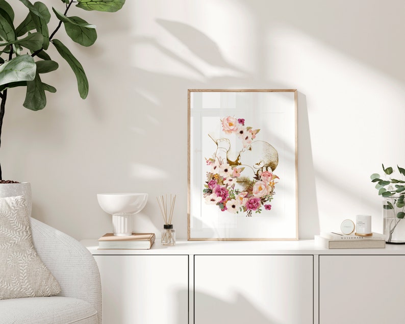 May include: A framed print of a watercolor illustration of a heart with pink and white flowers. The heart is surrounded by leaves and flowers in shades of pink, white, and green.