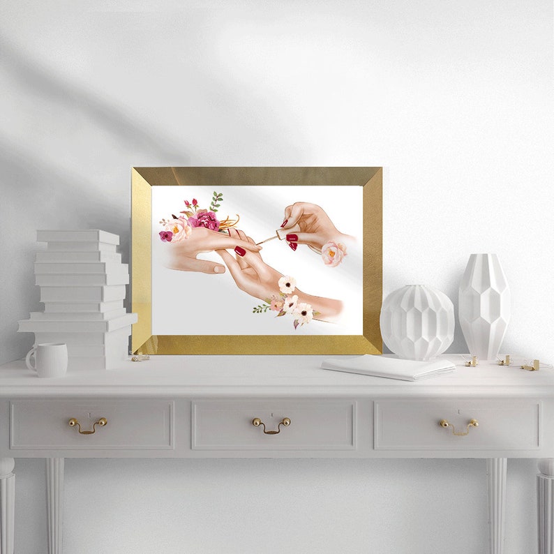 May include: A watercolor painting of two hands, one applying red nail polish to the other. The painting is framed in gold and features pink and white flowers.