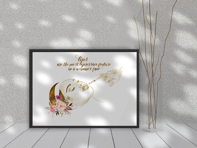 May include: A black framed print with a gold illustration of a woman receiving a lip injection. The text reads "Lips are the most expressive feature in a woman's face."