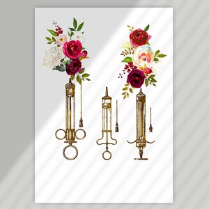 May include: Three antique syringes with floral accents. The syringes are gold-toned and have a vintage aesthetic. The flowers are red, pink, and white.