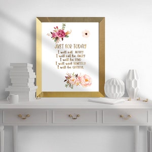 May include: A framed print with gold trim featuring the text "JUST FOR TODAY" in gold script. The print includes floral watercolor designs in pink and burgundy. The text reads: "I will not worry, I will not be angry, I will be kind, I will work honestly, I will be grateful."