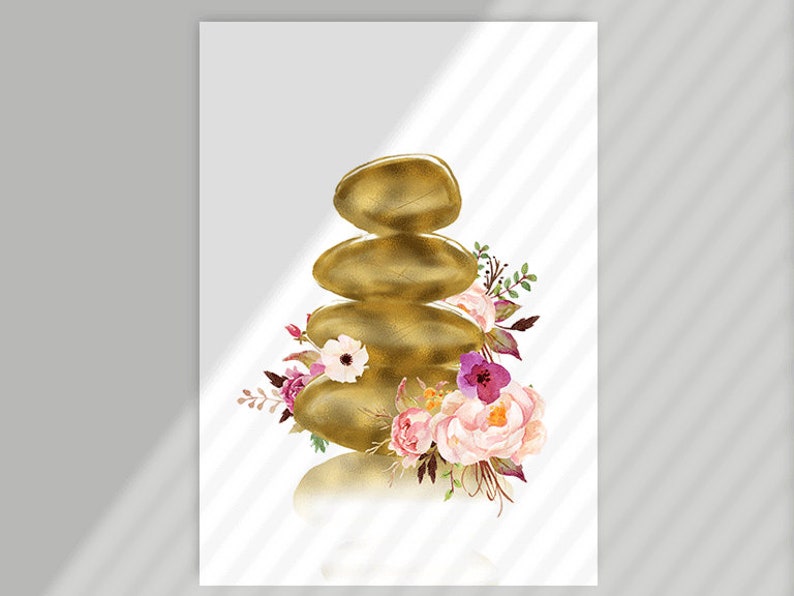 May include: A stack of golden stones with a floral arrangement of pink, purple, and white flowers. The flowers are arranged around the base of the stones.