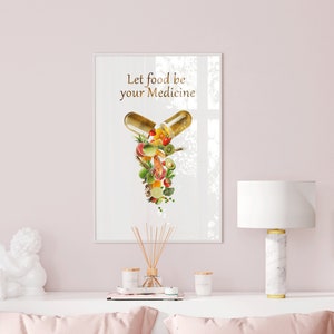 May include: A white framed print with the text "Let food be your medicine" and a graphic of a capsule filled with various fruits and vegetables.