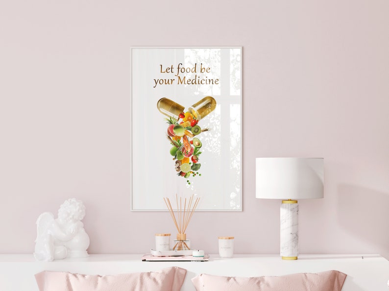May include: A white framed print with the text "Let food be your medicine" and a graphic of a capsule filled with various fruits and vegetables.