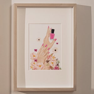 May include: A framed illustration of two hands with pink nail polish holding a bottle of pink nail polish. The hands are surrounded by pink and white flowers.