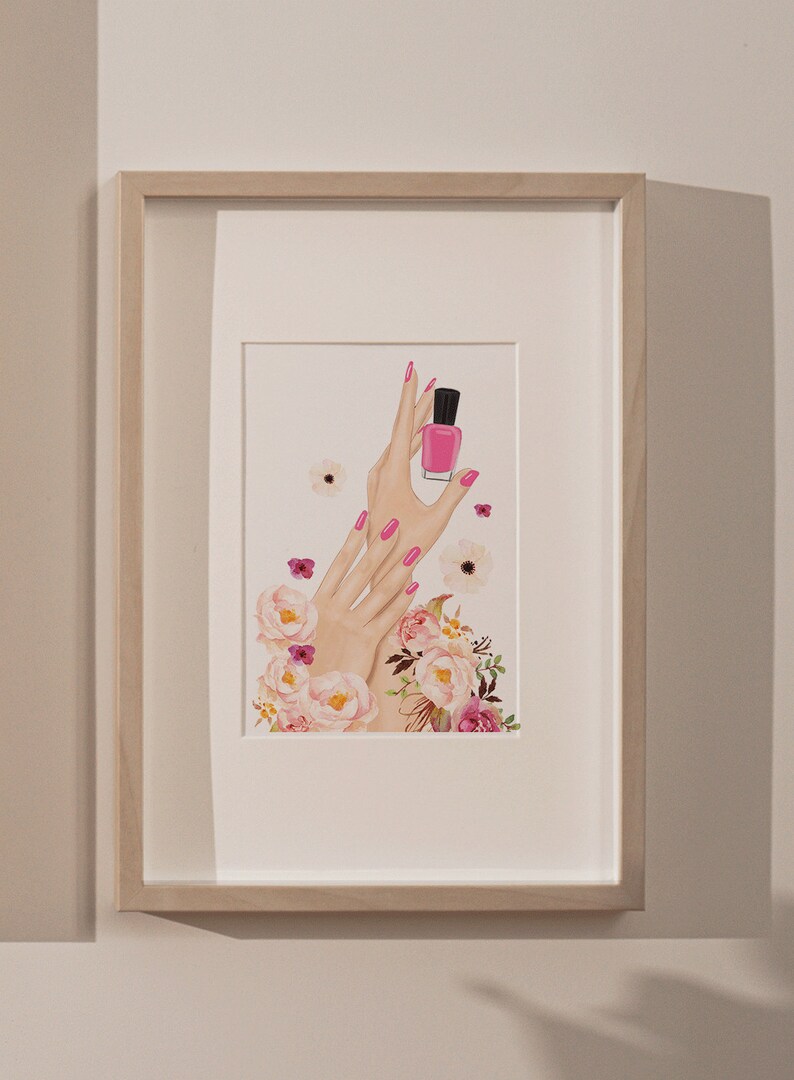 May include: A framed illustration of two hands with pink nail polish holding a bottle of pink nail polish. The hands are surrounded by pink and white flowers.