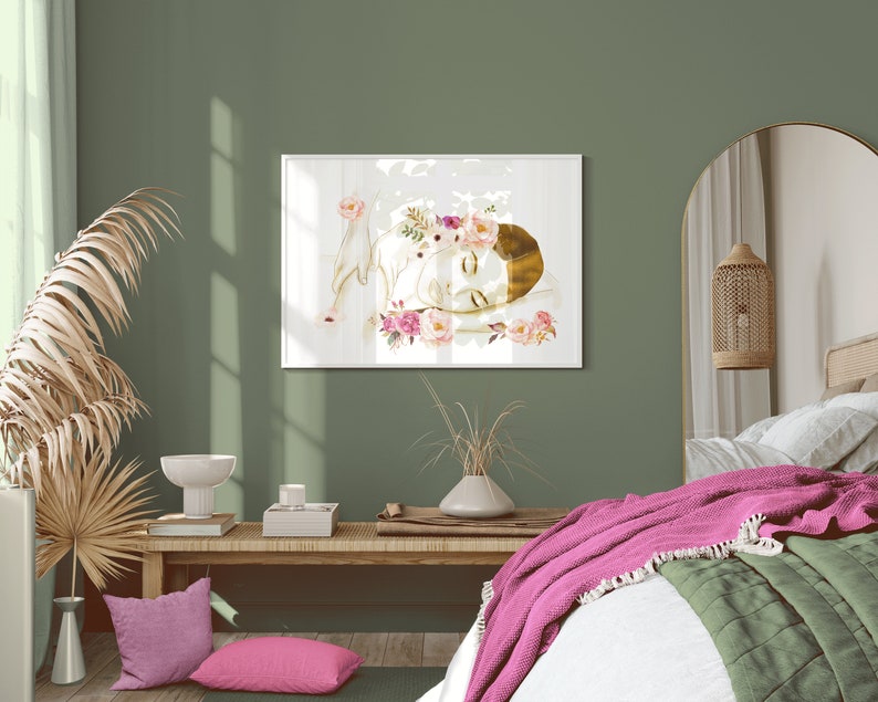 May include: A watercolour painting of a woman with a floral crown sleeping on a white background. The painting is framed and hanging on a green wall in a bedroom setting.