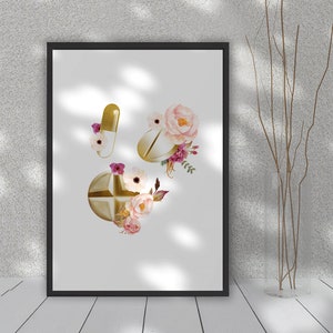 May include: A printable art print featuring a watercolor illustration of gold pills with pink and white flowers. The print is perfect for a doctor's office, pharmacy, or anyone who loves floral designs.