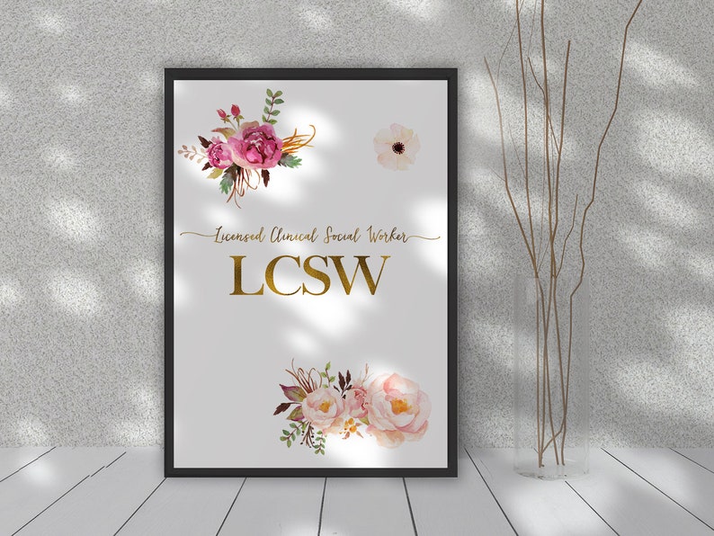 May include: A white framed print with a gold inscription that reads "Licensed Clinical Social Worker LCSW". The print is decorated with watercolor floral illustrations in shades of pink, white, and green.