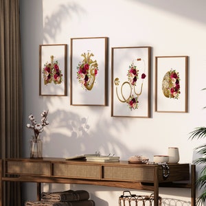 May include: Four framed prints with anatomical illustrations of the heart, lungs, brain, and stethoscope, all adorned with burgundy and gold floral arrangements.