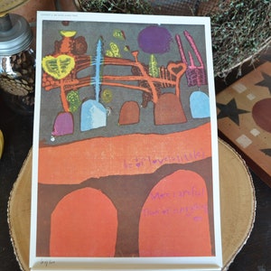 May include: A colorful abstract art print with a dark gray background, orange, yellow, blue, and purple shapes, and the text "be so love-little" and "More grateful than ever for everything".