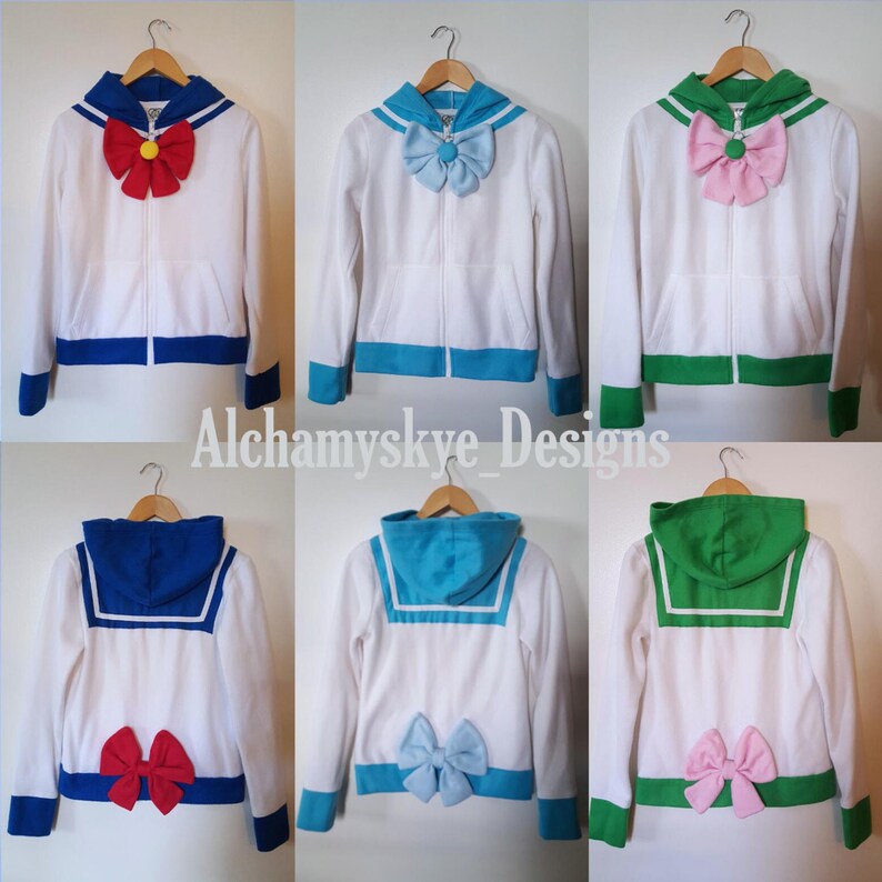May include: Six white zip-up hoodies with different colored sailor collars and bows. The collars are blue, green, and turquoise. The bows are red, pink, light blue, and green.