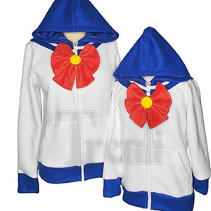 May include: Two white zip-up hoodies with blue hoods and cuffs. Both hoodies have a red bow with a yellow center on the front.