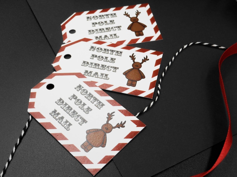 Blank on the back for your own message. North pole gift tag with Reindeer and candy stripe design