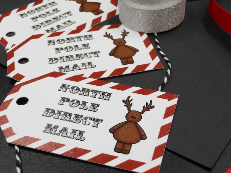 Blank on the back for your own message. North pole gift tag with Reindeer and candy stripe design