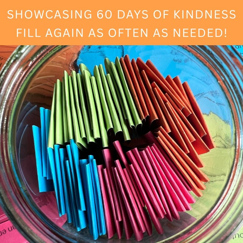May include: A glass jar filled with folded slips of paper in green, orange, blue, and pink. The jar is labeled "SHOWCASING 60 DAYS OF KINDNESS FILL AGAIN AS OFTEN AS NEEDED!"