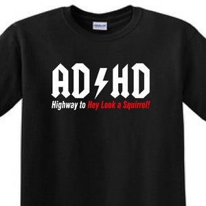 May include: Black t-shirt with white text that reads "AD/HD Highway to Hey Look a Squirrel!"