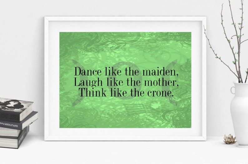 May include: A green and white framed print with the text "Dance like the maiden, Laugh like the mother, Think like the crone."