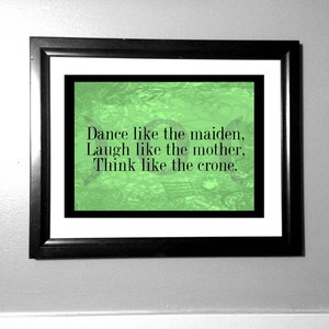 May include: A framed print with a green background and the text "Dance like the maiden. Laugh like the mother. Think like the crone."