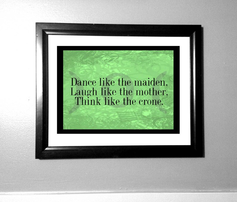 May include: A framed print with a green background and the text "Dance like the maiden. Laugh like the mother. Think like the crone."