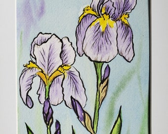 May include: Watercolour painting of two purple iris flowers with yellow centres on a light blue background. The flowers are drawn with fine lines and have a delicate, whimsical feel. The artist's signature, "JAM", is visible in the bottom right corner.
