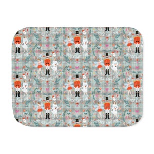 May include: A repeating pattern featuring a nutcracker, a ballerina, and a Christmas tree on a blue and white plaid background. The pattern includes the text "Peace Love Joy".