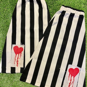 Black and white striped flared cotton leg warmers with bleed heart patches