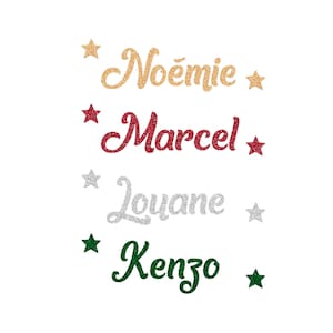 Può includere: Nomi glitterati: Noémie in oro, Marcel in rosso, Louane in argento e Kenzo in verde. Ogni nome è accompagnato da una stella. Festivo e decorativo, perfetto per creazioni natalizie personalizzate o regali.