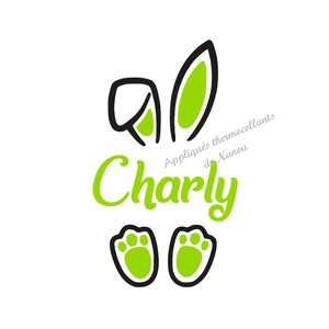 Könnte beinhalten: Ein Grafikdesign mit Hasenohren, Pfotenabdrücken und dem Namen "Charly" in Grün. Die Hasenohren und Pfotenabdrücke haben eine schwarze Umrandung mit grüner Füllung. Der Text "Appliqués thermocollants de Nanou" ist ebenfalls vorhanden.