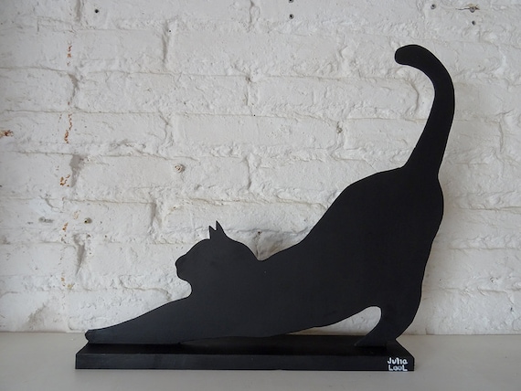 CAT STRETCHING.  Street art. Black cat by the Valencian artist Julia Lool made of DM wood.