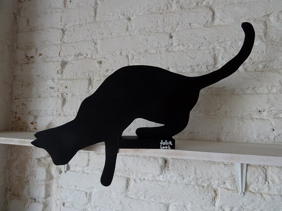 JUMPING CAT. Street art. A black cat by Valencian artist Julia Lool, made of MDF.