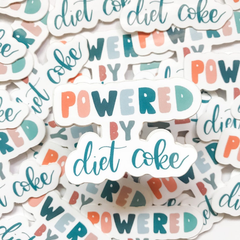May include: A collection of stickers with the phrase "Powered by Diet Coke" in colorful, bubbly letters. The stickers are on a white background and feature various designs, including the words "Diet Coke" and "Powered by" in different fonts and colors.