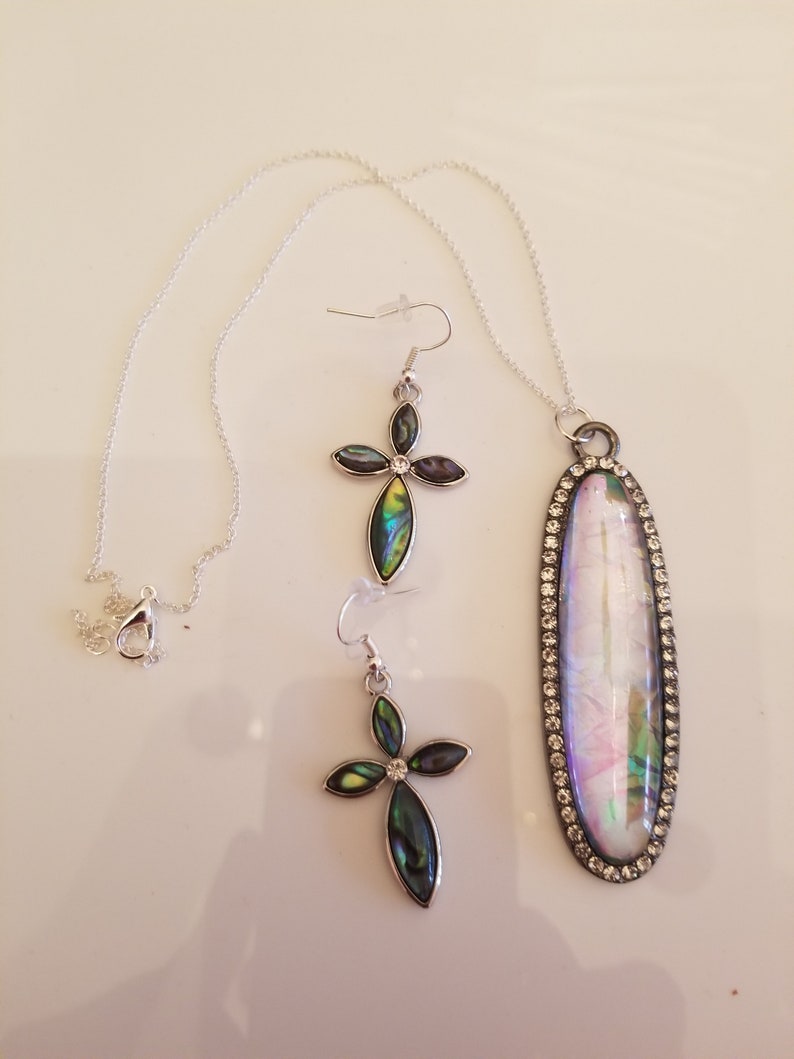 Clear Oval Pendant Necklace with shades of green and gold accents and a pair of matching Cross Earrings SKU #UVF2PP125