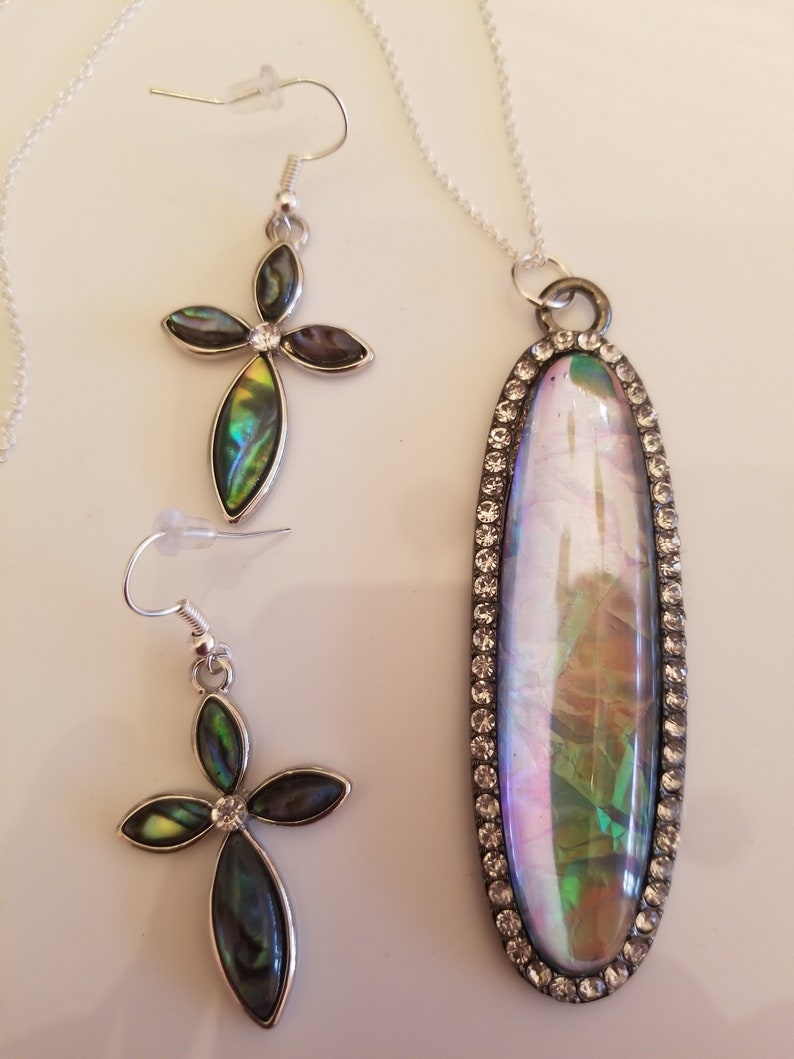 Clear Oval Pendant Necklace with shades of green and gold accents and a pair of matching Cross Earrings SKU #UVF2PP125