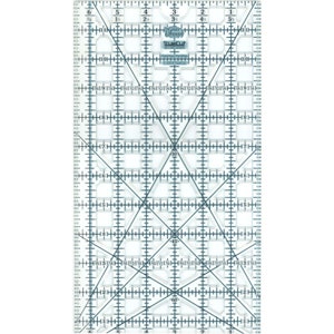 May include: A clear plastic ruler with a grid pattern and diagonal lines. The ruler has markings in inches and includes angle markings for 30, 45, and 60 degrees. The ruler is labelled "TrueCut" and "Made in USA".