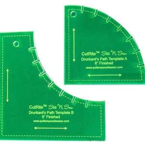 Peut inclure: Deux gabarits de patchwork en plastique vert pour les blocs Drunkard's Path. Les gabarits sont étiquetés "CutRite™ Slit 'n Sew Drunkard's Path Template A 6" Finished" et "CutRite™ Slit 'n Sew Drunkard's Path Template B 6" Finished".
