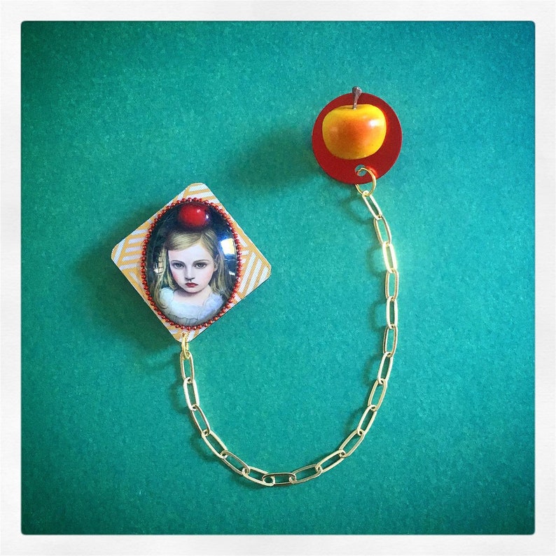 Young girl brooch with apple