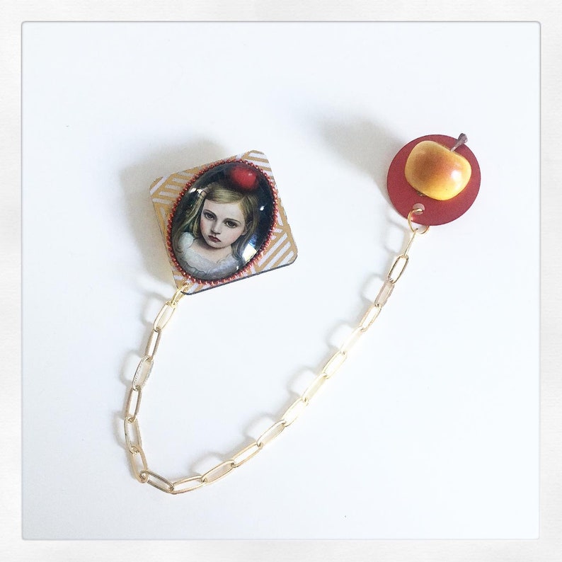 Young girl brooch with apple