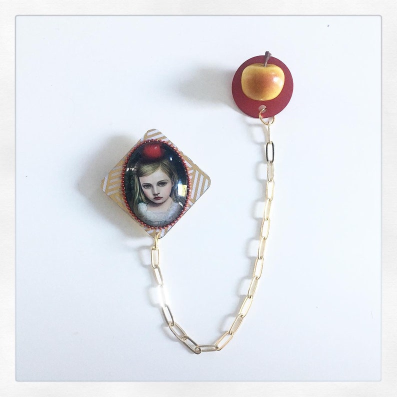 Young girl brooch with apple