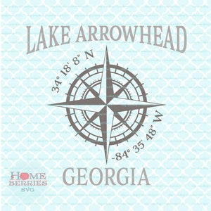 May include: A compass with a gray background and black lines, with the text "LAKE ARROWHEAD" at the top, "34° 18' 8" N" on the left, "-84° 35' 48" W" on the right, and "GEORGIA" at the bottom.