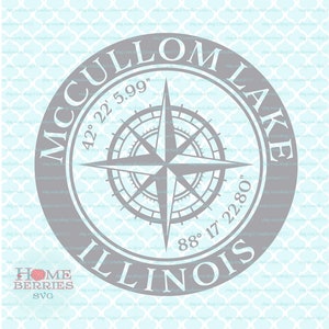 May include: A gray circle with a compass rose in the center. The circle has the text "MCCULLOM LAKE ILLINOIS" around the outside. The coordinates "42° 22' 5.99" and "88° 17' 22.80" are also included.