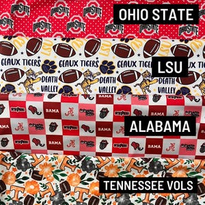 May include: Four horizontal strips of collegiate-themed fabric. The top features red Ohio State logos. The second shows LSU footballs, tigers, and text. The third displays a red and white checkered Alabama pattern. The bottom shows Tennessee Vols floral prints.