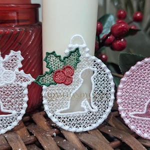 May include: Three white and pink Christmas ornaments with a dog silhouette design. The ornaments are made of lace and have a delicate, intricate design. The ornaments are decorated with holly leaves and berries.