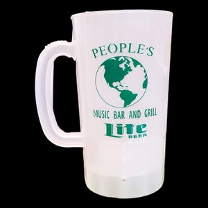 May include: A clear plastic beer mug with a large handle. The mug has green text that reads "PEOPLE'S MUSIC BAR AND GRILL Lite BEER" with a globe graphic. The mug is empty and ready to be filled.