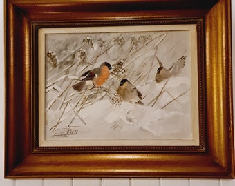 May include: A framed painting of three birds in a snowy landscape. The birds are brown, gray, and red with black eyes. The painting is set against a white background with a gold frame.