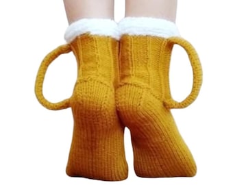 May include: A pair of yellow knitted socks with white cuffs and a loop on each side. The socks are made of a soft, warm material and are perfect for keeping your feet cozy.