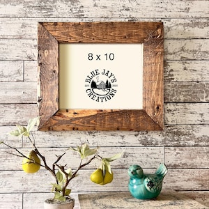 May include: A rustic wooden frame with a white mat and a black and white logo that says "Blue Jay's Creations Est. 2024" inside. The frame is 8x10 inches.