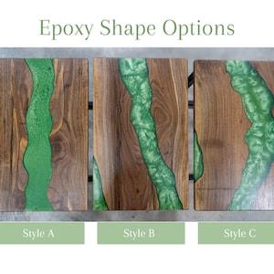 May include: Three wooden tabletops with different epoxy resin river designs. The epoxy is a vibrant green color and flows through the wood. The tabletops are labeled Style A, Style B, and Style C.